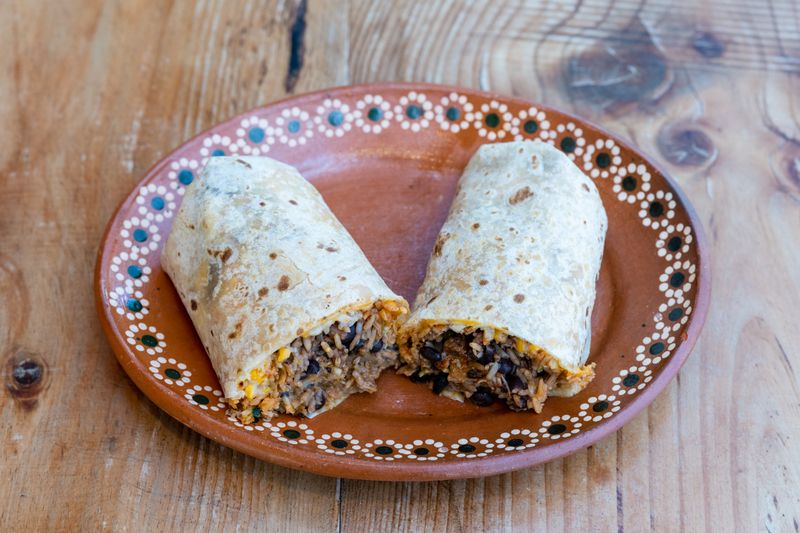 Massive stuffed burrito with rice beans and chicken