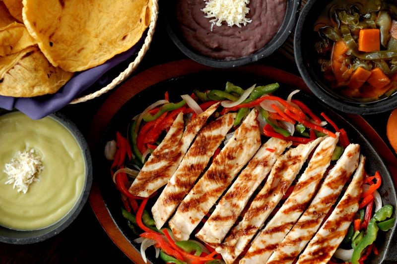 Sizzling chicken fajitas with peppers and onions